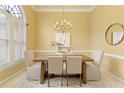 Elegant dining room with modern chandelier, a light color palette and beautiful hardwood floors at 710 Eastbourne Ct, Alpharetta, GA 30005