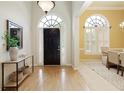 Bright foyer with hardwood floors, a transom window, and an adjacent dining area at 710 Eastbourne Ct, Alpharetta, GA 30005