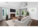 Bright living room with a fireplace, hardwood floors, and an abundance of natural light from large windows at 969 Oak Sw St, Atlanta, GA 30310