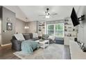 Bright living room featuring built-in bookshelves, a large window, a ceiling fan, and hardwood floors at 1501 Jamerson Landing, Marietta, GA 30066