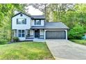 Charming two-story home with a well-manicured lawn and an attached two-car garage at 2211 Rocky Mill Dr, Lawrenceville, GA 30044