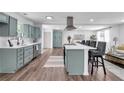 Open-concept kitchen with stainless steel appliances, a center island with bar stools, and hardwood flooring at 30 Dewey Se Ln, Marietta, GA 30060