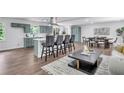 Modern kitchen with gray-blue cabinetry, a central island with seating, and an open layout to the dining area at 30 Dewey Se Ln, Marietta, GA 30060