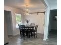 Bright dining room with a stylish chandelier and sliding barn door at 735 Brookwood Dr, Forest Park, GA 30297