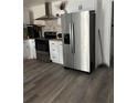 Modern kitchen featuring stainless steel refrigerator and white cabinetry at 735 Brookwood Dr, Forest Park, GA 30297
