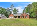 A charming brick home with an attached garage and a spacious front lawn at 9959 Point View Dr, Jonesboro, GA 30238