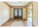 Warm foyer showcasing beautiful wood flooring and a decorative double front door at 9959 Point View Dr, Jonesboro, GA 30238