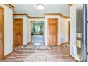 Inviting foyer with wood floors, trim, and doors leading into the living area at 9959 Point View Dr, Jonesboro, GA 30238
