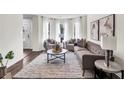 Comfortable living room filled with natural light from large windows at 1075 Litchfield Sw Way, Marietta, GA 30060