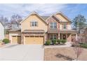 Beautiful two-story home with a three-car garage and well-maintained lawn in a suburban neighborhood at 965 Mulberry Bay Dr, Dacula, GA 30019