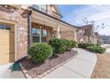Charming front porch with brickwork, manicured bushes, and a welcoming walkway at 965 Mulberry Bay Dr, Dacula, GA 30019