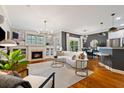 Stylish living area showcasing a fireplace, open layout, hardwood floors, and a modern chandelier at 1242 Morton Trce Se, Atlanta, GA 30316