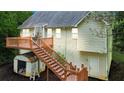 View of backyard showing elevated deck, stairs, storage shed, and home's exterior at 59 Abbotsford Dr, Villa Rica, GA 30180