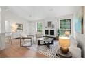 Living room featuring wood floors, fireplace, contemporary furniture, and natural light from two windows at 1490 Diplomat Dr, Riverdale, GA 30296