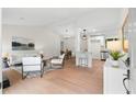Open-concept living room featuring bright interior, wood floors, and stylish contemporary furniture at 1490 Diplomat Dr, Riverdale, GA 30296