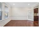 Bright living room with hardwood floors, white wainscoting and trim, and natural light at 5195 Belmore Manor Ct, Suwanee, GA 30024