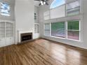 Bright living room with vaulted ceilings, large windows, fireplace, and hardwood floors at 9979 Bridgewater Pointe, Villa Rica, GA 30180