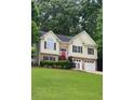 Charming two-story home with brick accents, a well-manicured lawn, and a welcoming front entrance at 136 Walkers Pond Dr, Villa Rica, GA 30180
