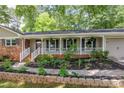 Inviting covered porch with white columns and a brick walkway leading to the front door at 1732 Samaria Trl, Tucker, GA 30084