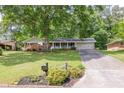 Traditional home with an attached garage, long driveway, and a lush green lawn at 1732 Samaria Trl, Tucker, GA 30084