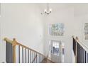 Bright entryway with wood floors, an open staircase, and a view into the adjacent living area at 3279 Greenhill Dr, Villa Rica, GA 30180