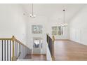 Bright entryway with wood floors, an open staircase, and a view into the adjacent living area at 3279 Greenhill Dr, Villa Rica, GA 30180
