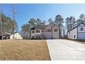 Charming two-story home with a symmetrical design, featuring a long concrete driveway and manicured lawn at 3279 Greenhill Dr, Villa Rica, GA 30180