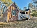 Charming brick home with covered front porch, green shutters, and inviting curb appeal at 342 Mccurry Rd, Stockbridge, GA 30281