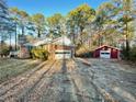 Exterior view of a brick home with a two-car garage and a detached storage shed in the backyard at 342 Mccurry Rd, Stockbridge, GA 30281