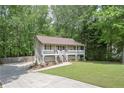 Quaint home with inviting front porch, and a concrete driveway at 92 Confidence Ct, Temple, GA 30179