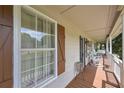 Inviting covered front porch with rocking chairs, bench and decorative wood shutters at 92 Confidence Ct, Temple, GA 30179