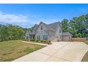 Charming two-story home with light blue siding, grey accents and a large paved driveway at 101 Ruby Lane, Mcdonough, GA 30252