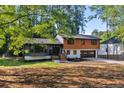 Charming two-story home with manicured lawn, two-car garage, and wood-paneled facade at 1129 Pinehurst Rd, Grayson, GA 30017