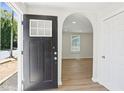 View of the home's light and airy entryway featuring an archway and durable wood-look flooring at 130 South Se Ave, Marietta, GA 30060