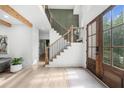 Elegant entryway with stairs, wood floors, and a stylish front door with lots of natural light at 1358 Peppergrass Nw Trl, Acworth, GA 30101