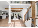 Bright foyer showcasing hardwood floors, stairs, beams and an open concept design to the living spaces at 1358 Peppergrass Nw Trl, Acworth, GA 30101