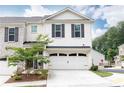 Charming two-story townhouse features a well-maintained lawn and a two-car garage with ample parking at 500 Garvin Dr, Woodstock, GA 30189
