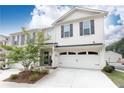 Inviting two-story townhouse boasts of beautiful landscaping and a convenient two-car garage at 500 Garvin Dr, Woodstock, GA 30189