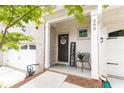 Inviting front porch with brick accents, 'WELCOME' sign and a cozy seating area, perfect for relaxing at 500 Garvin Dr, Woodstock, GA 30189
