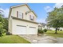 Two-story home with a two-car garage, red shutters and a well-kept front lawn and mature tree at 436 Berkshire Pl, Fairburn, GA 30213