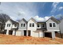 New construction townhomes featuring varied gray and white siding with an open garage at 11612 E Lovejoy Rd, Hampton, GA 30228