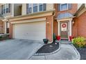 Close-up of a well-maintained townhome exterior with a prominent front door and attached garage at 5800 Oakdale Se Rd # 147, Mableton, GA 30126