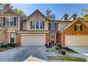 Inviting townhome with a welcoming front entrance and a two-car garage, framed by manicured landscaping at 5800 Oakdale Se Rd # 147, Mableton, GA 30126