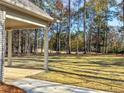 View of the expansive backyard and well-maintained lawn from the covered porch showing the outdoor space at 1874 Mcgarity Rd, Mcdonough, GA 30252