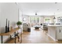 Bright living room with wood floors, a fireplace, modern decor, and natural light from large windows at 2167 Crestridge Ne Trl, Brookhaven, GA 30329