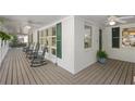 Spacious front porch offers ample seating with multiple rocking chairs and ceiling fans at 2515 Ridgewood Nw Rd, Atlanta, GA 30318