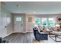 Cozy living room featuring neutral walls, hardwood floors, and a comfortable couch and sitting chairs at 2932 Valley Ridge Dr, Decatur, GA 30032