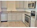 Well-lit kitchen featuring granite countertops, stainless appliances, and ample cabinet space at 115 Deer Xing, Temple, GA 30179
