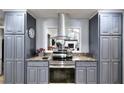 Charming kitchen features granite countertops, stainless steel appliances and a view to the living room at 1379 Branchwood Dr, Snellville, GA 30078