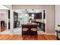 Open kitchen view with dark wood cabinetry, granite countertops, and a central island with seating at 2771 Stonecreek Se Rd, Smyrna, GA 30080